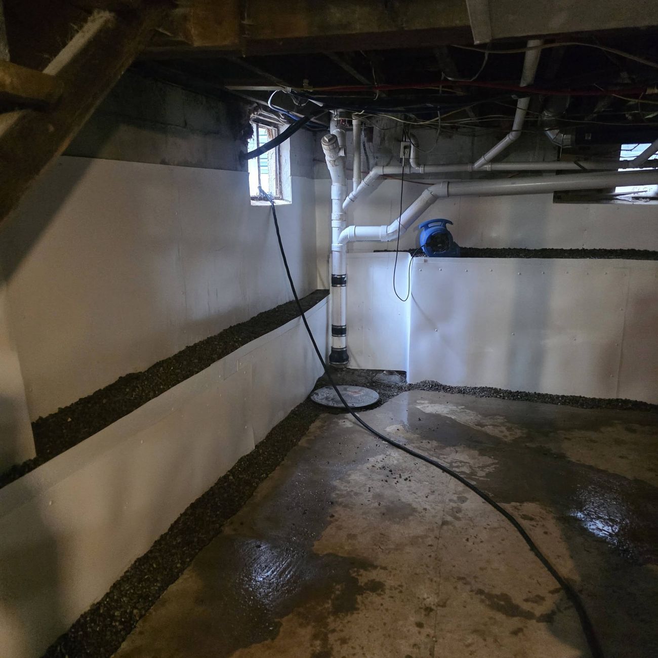 A basement interior being waterproofed