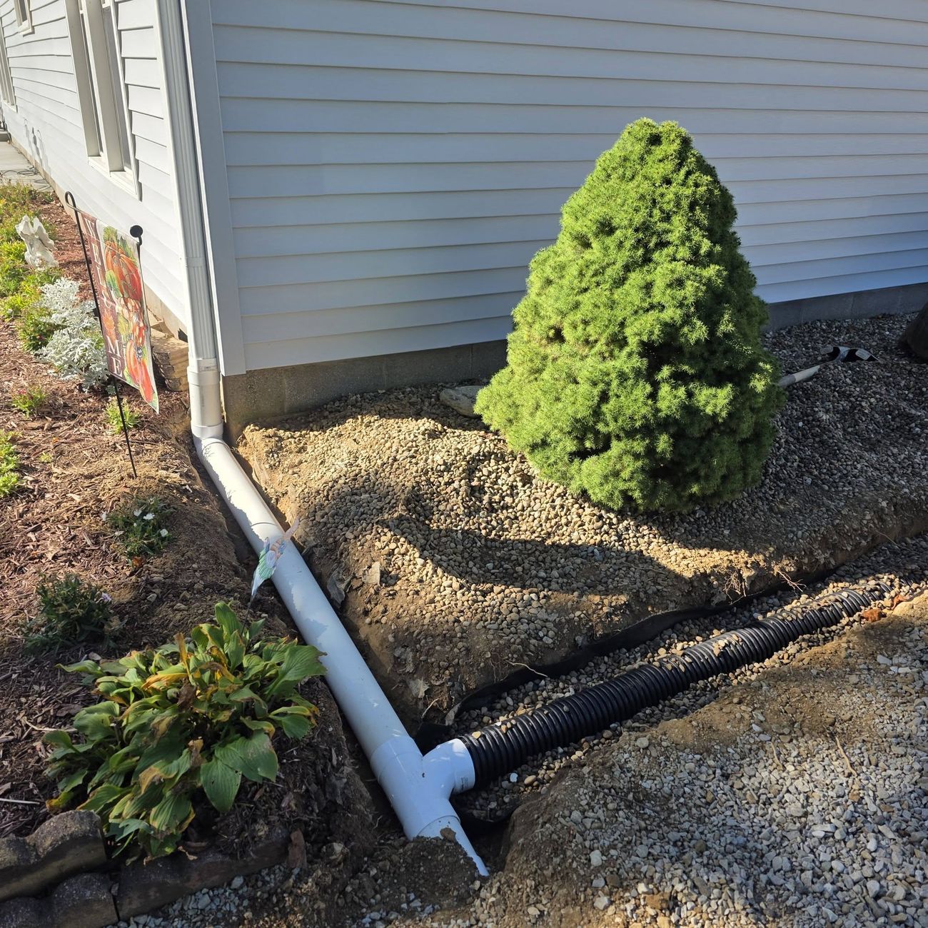 A downspout connected into a solid underground drain line