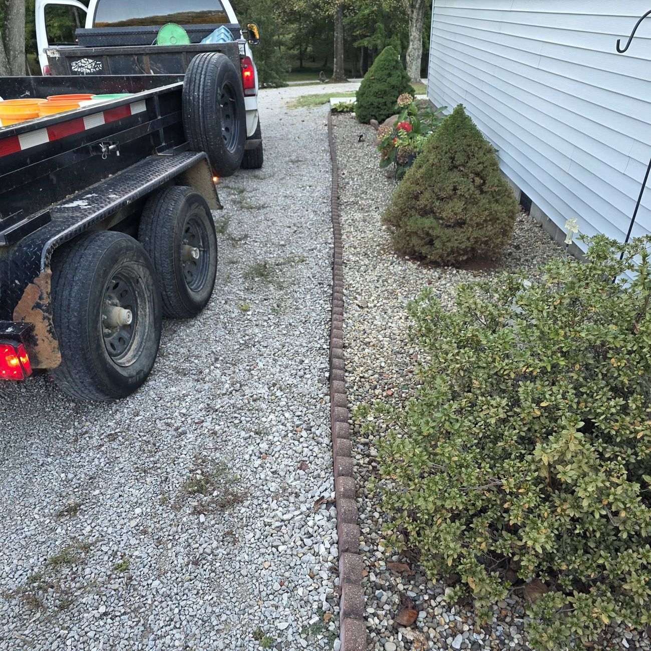A gravel path edged neatly beside a house
