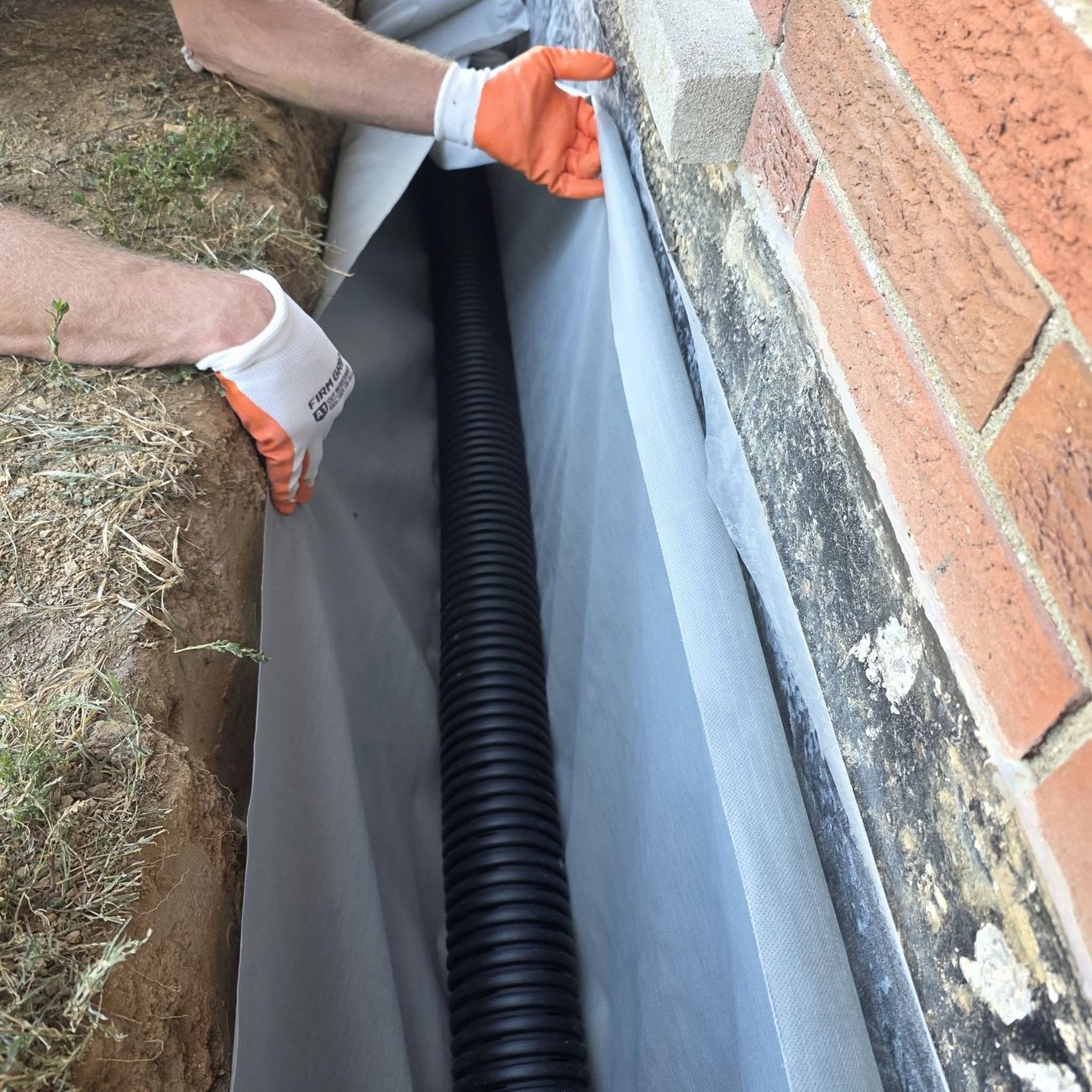 Waterproofing membrane being fitted against a foundation wall